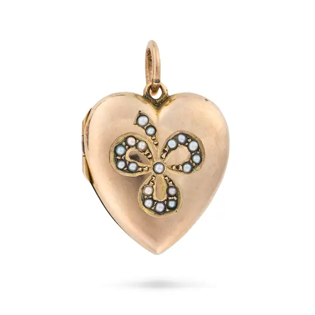 AN ANTIQUE PEARL HEART LOCKET PENDANT in 9ct yellow gold and silver, designed as a heart with a