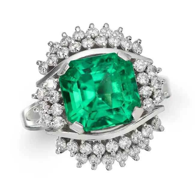 A FINE COLOMBIAN INSIGNIFICANT EMERALD AND DIMOND RING set with an octagonal step cut emerald of 3.