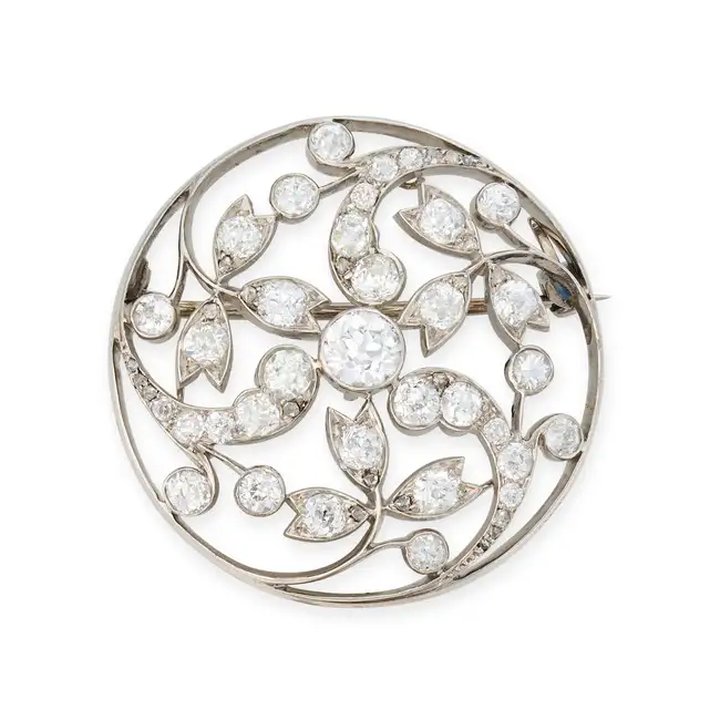 AN ANTIQUE DIAMOND BROOCH the openwork pendant in foliate design, set with old and rose cut