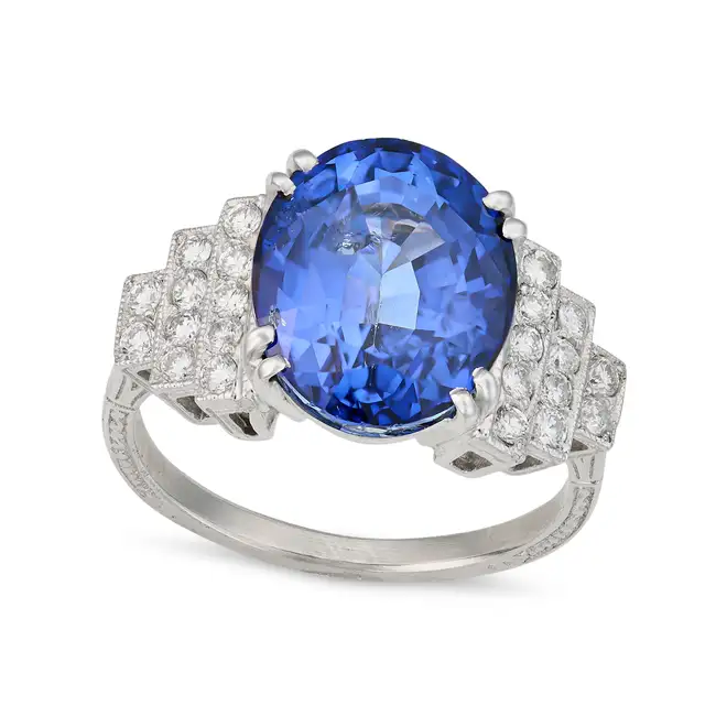 A FINE SAPPHIRE AND DIAMOND DRESS RING set with an oval cut sapphire of approximately 7.74 carats,