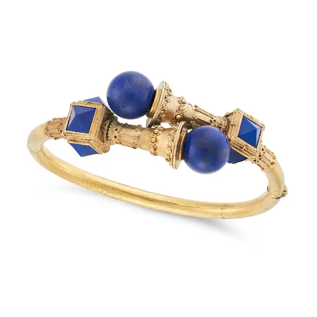 AN ANTIQUE ETRUSCAN REVIVAL LAPIS LAZULI BANGLE in yellow gold, the hinged bangle in crossover