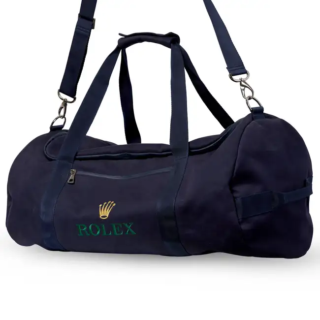NO RESERVE - ROLEX, A BLUE CANVAS DUFFLE BAG Dark blue canvas exterior with canvas handles, a