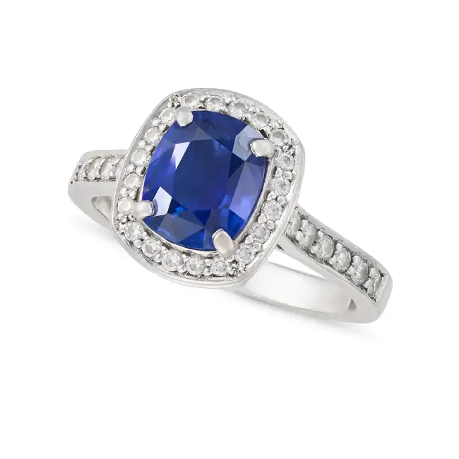 A FINE SAPPHIRE AND DIAMOND RING in platinum, set with a cushion cut sapphire of approximately 2.