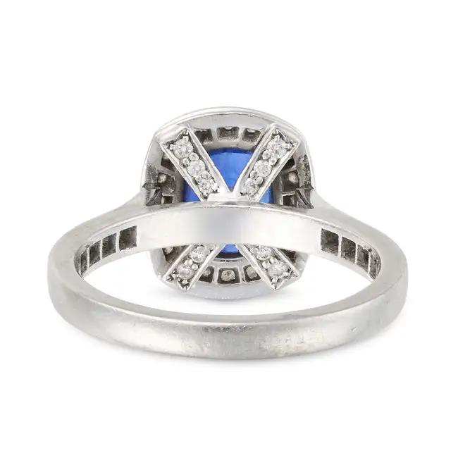 A FINE SAPPHIRE AND DIAMOND RING in platinum, set with a cushion cut sapphire of approximately 2.