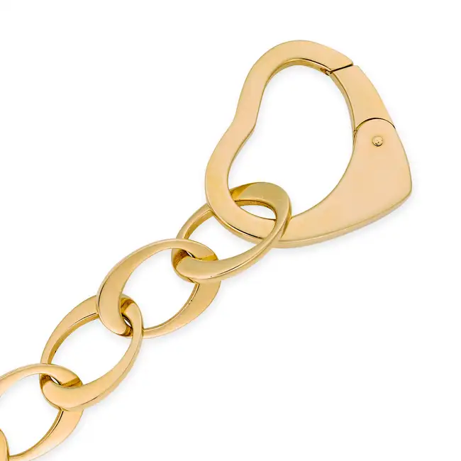 MAPPIN & WEBB, A GOLD HEART BRACELET in 18ct yellow gold, comprising a row of oval links, the