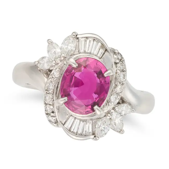 NO RESERVE - A FINE RUBY AND DIAMOND DRESS RING in platinum, set with an oval cut ruby of 1.61