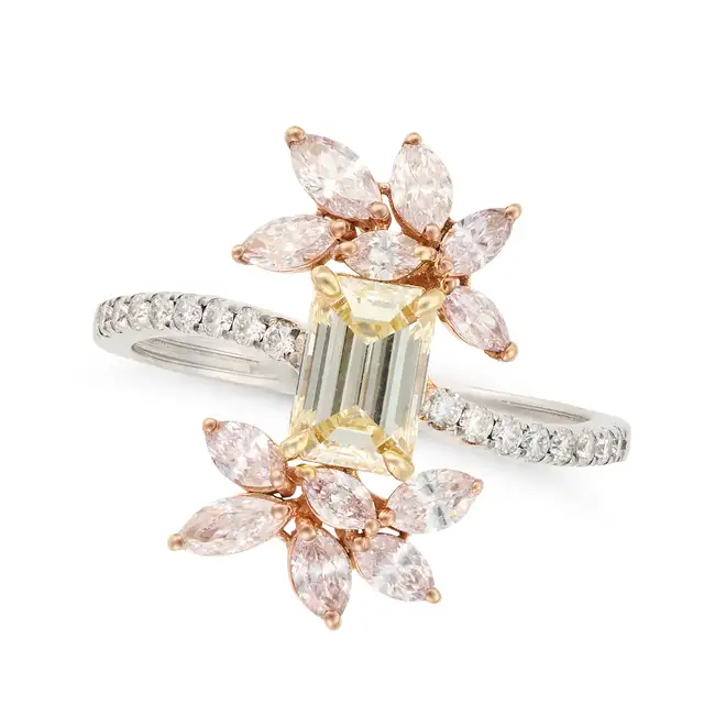 A YELLOW AND PINK DIAMOND RING set with an emerald cut yellow diamond, accented by sprays of