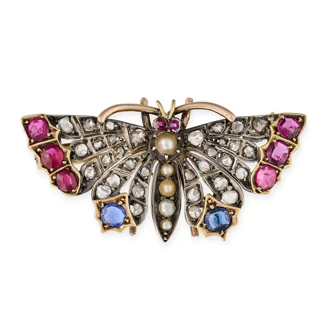 AN ANTIQUE RUBY, SAPPHIRE, DIAMOND AND PEARL BUTTERFLY BROOCH in yellow gold and silver, designed as