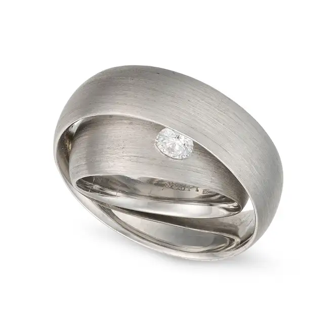 SCHWAB, A DIAMOND BAND RING comprising two bands with a brushed finish, set with a round brilliant