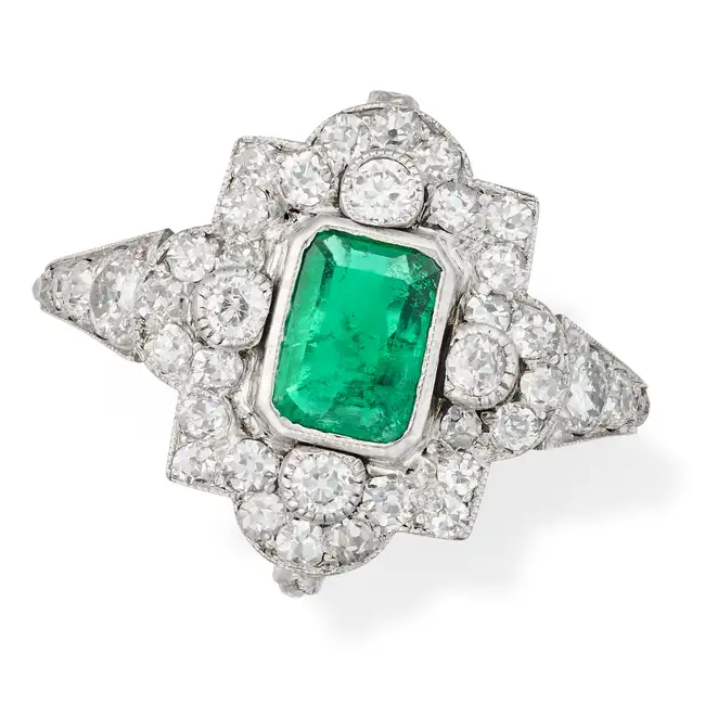 AN EMERALD AND DIAMOND DRESS RING, EARLY 20TH CENTURY set with an octagonal step cut emerald of