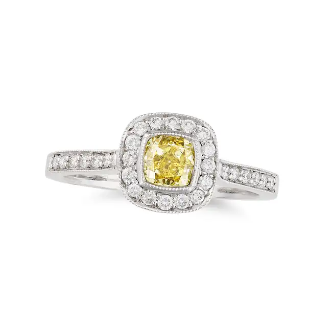 A FANCY YELLOW DIAMOND RING in platinum, set with a modified square brilliant cut diamond of 0.57