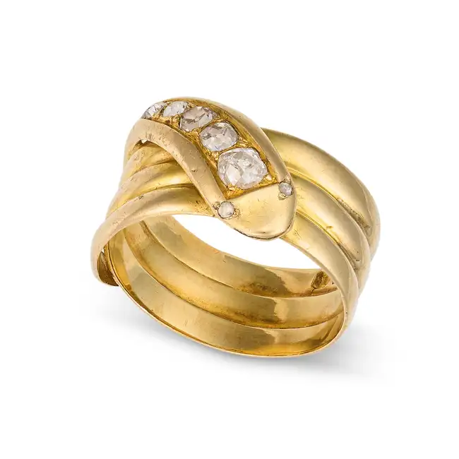 AN ANTIQUE VICTORIAN DIAMOND SNAKE RING,1884 in 18ct yellow gold, designed as a coiled snake, the