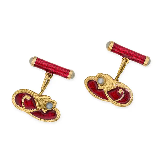 FABERGE, A PAIR OF MOONSTONE AND ENAMEL DRAGON CUFFLINKS each designed as a coiled dragon set with a