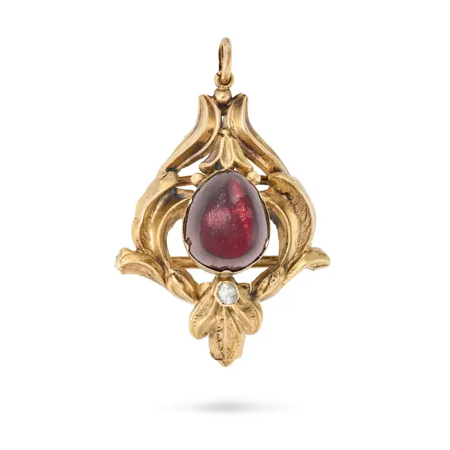 AN ANTIQUE VICTORIAN GARNET AND DIAMOND PENDANT the foliate style pendant set with a cabochon garnet