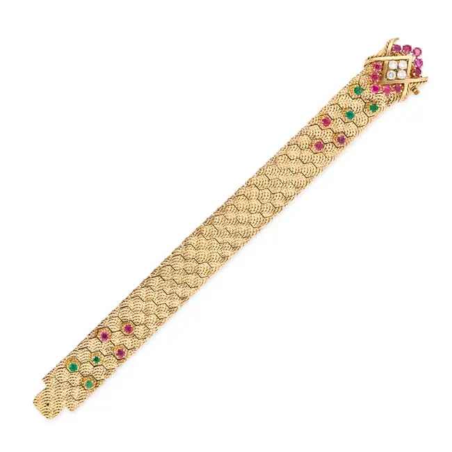 MAUBOUSSIN, A FINE VINTAGE RUBY, EMERALD AND DIAMOND BRACELET in 18ct yellow gold, comprising a