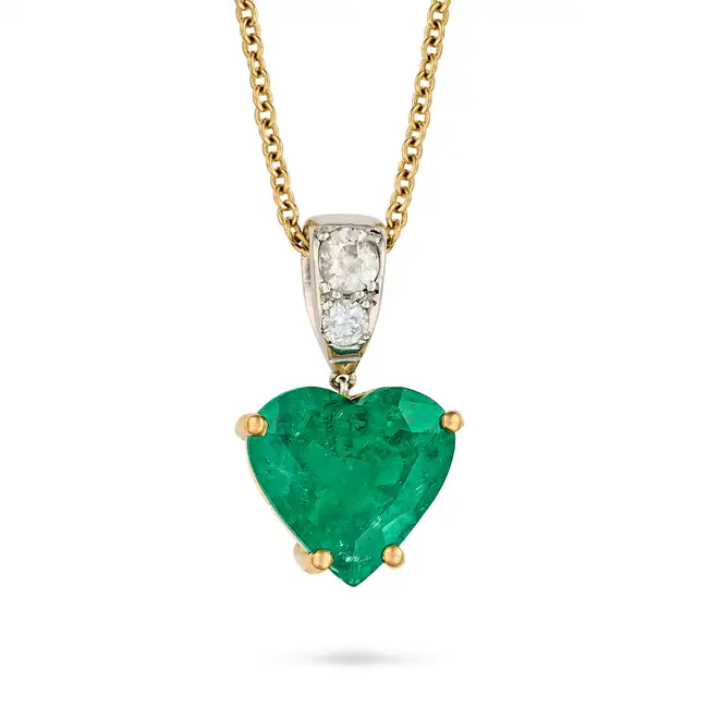 A ZAMBIAN MINOR EMERALD AND DIAMOND HEART PENDANT NECKLACE in 18ct yellow gold, the pendant set with