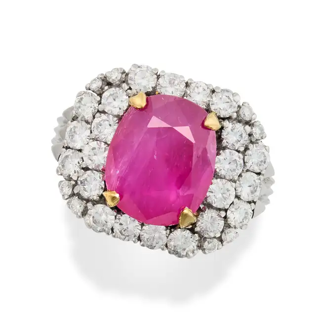 A BURMA NO HEAT RUBY AND DIAMOND RING set with a cushion cut ruby of approximately 4.89 carats in