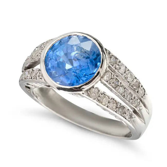 A CEYLON NO HEAT SAPPHIRE AND DIAMOND RING set with a round cut sapphire of 3.52 carats, the
