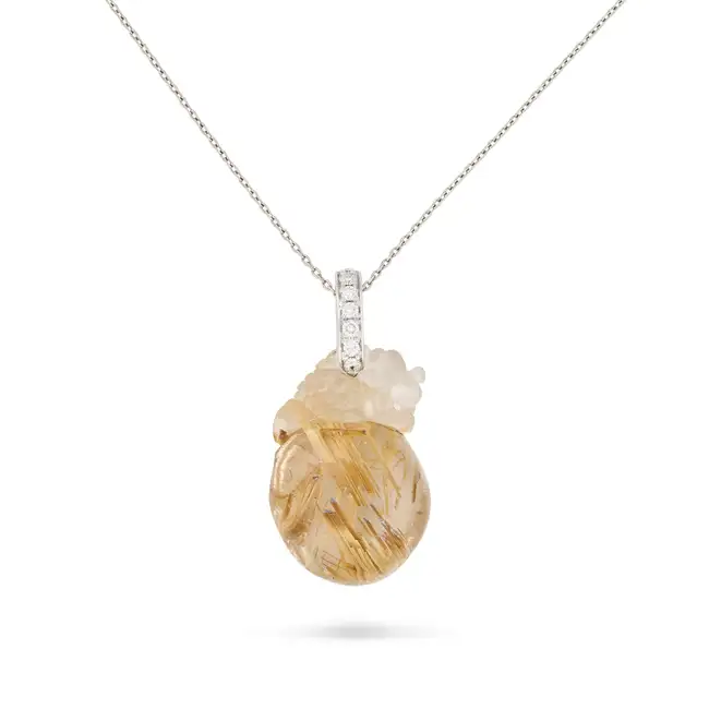A RUTILATED QUARTZ AND DIAMOND DRAGON PENDANT NECKLACE in platinum, the pendant set with polished