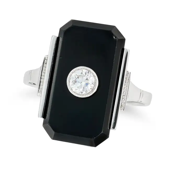 AN ART DECO DIAMOND AND ONYX DRESS RING comprising an octagonal black onyx set with an old