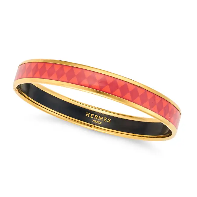 NO RESERVE - HERMES, AN ENAMEL BANGLE decorated all around with a orange and red enamel, signed
