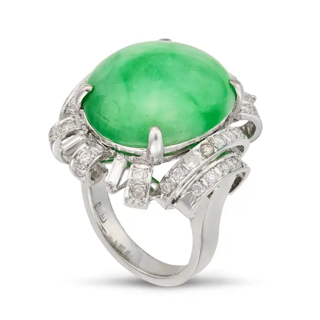 ​AN UNTREATED JADEITE JADE AND DIAMOND RING set with an oval cabochon jadeite jade of