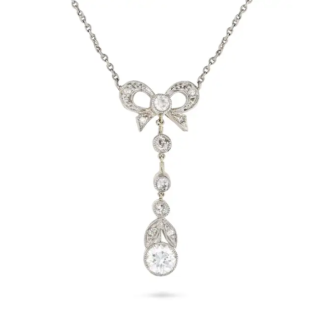 A DIAMOND PENDANT NECKLACE, EARLY 20TH CENTURY AND LATER the pendant designed as a bow set with