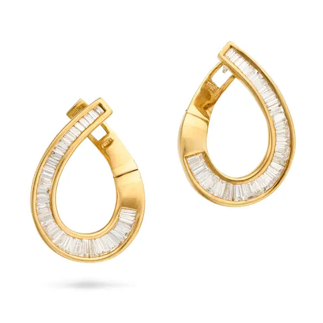 A PAIR OF DIAMOND EARRINGS each earring designed as a scroll, set with tapered baguette cut
