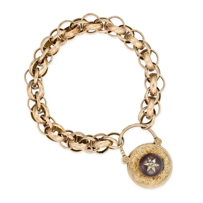 AN ANTIQUE VICTORIAN GARNET AND DIAMOND PADLOCK BRACELET comprising a row of fancy hammered links,
