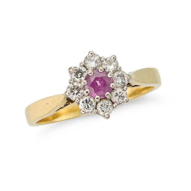 A VINTAGE RUBY AND DIAMOND CLUSTER RING in 18ct yellow gold, set with a round cut ruby within a