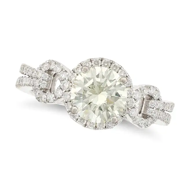 A DIAMOND DRESS RING set with a round brilliant cut diamond of approximately 1.50 carats, the
