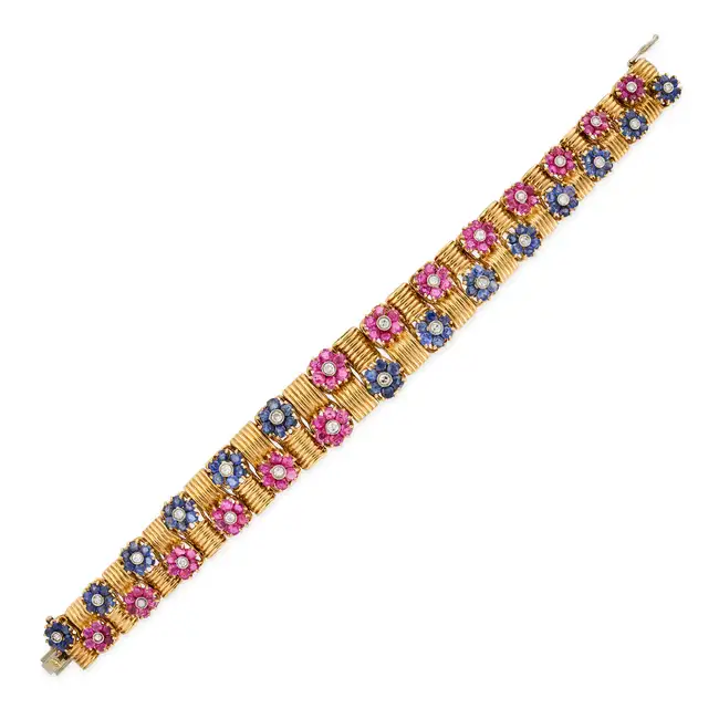 A VINTAGE RUBY, SAPPHIRE AND DIAMOND BRACELET in 18ct yellow gold, comprising fluted links, accented