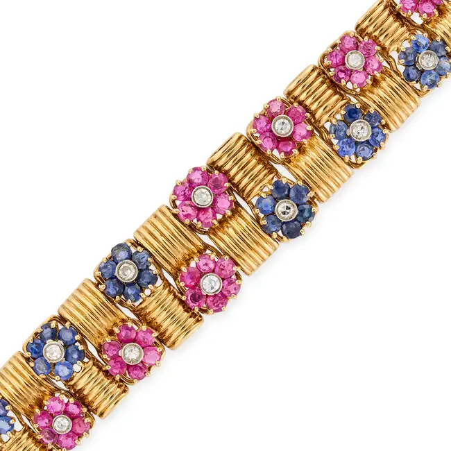 A VINTAGE RUBY, SAPPHIRE AND DIAMOND BRACELET in 18ct yellow gold, comprising fluted links, accented