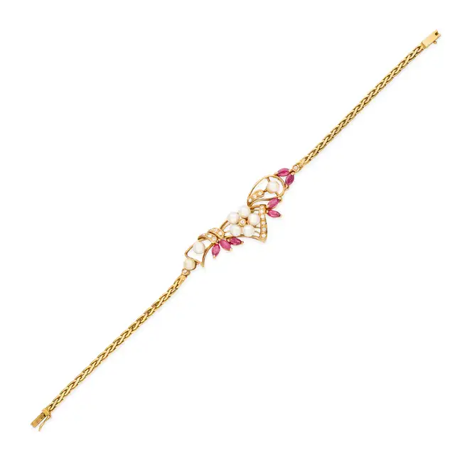 NO RESERVE - A RUBY, PEARL AND DIAMOND BRACELET in 18ct yellow gold, in foliate design, set with a