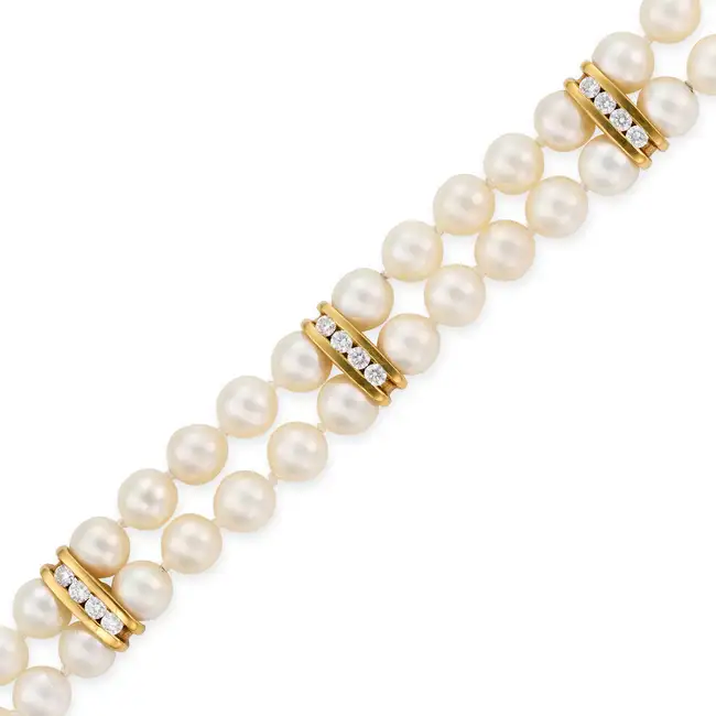 NO RESERVE - A PEARL AND DIAMOND BRACELET in 18ct yellow gold and white gold, comprising two rows of