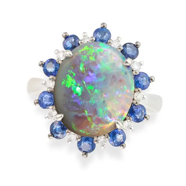 NO RESERVE - AN OPAL, SAPPHIRE AND DIAMOND CLUSTER RING set with an oval cabochon opal of 2.74
