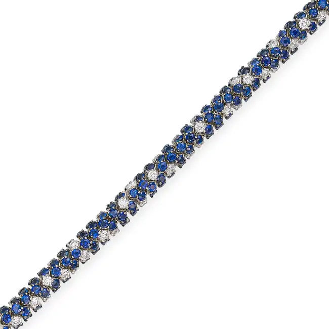 A SAPPHIRE AND DIAMOND BRACELET set throughout with round cut sapphires, accented by round brilliant