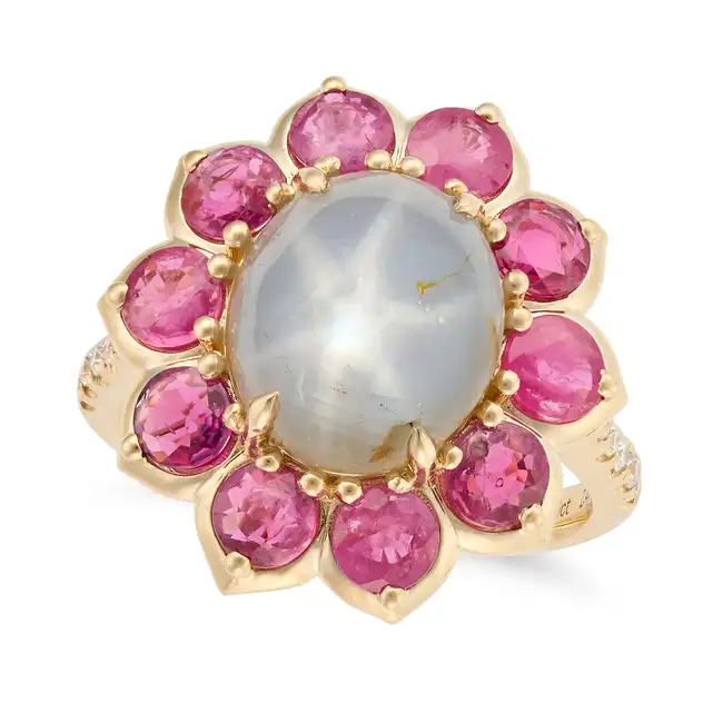 A STAR SAPPHIRE, RUBY AND DIAMOND CLUSTER RING set with an oval cabochon star sapphire of 8.30