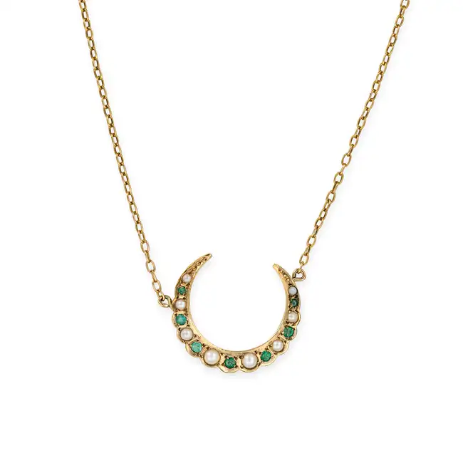 A PEARL AND EMERALD CRESCENT MOON NECKLACE the pendant designed as a crescent moon set with pearls