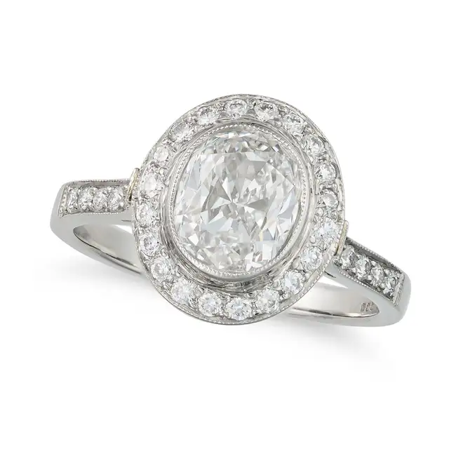 A FINE DIAMOND HALO RING in platinum, set with a cushion cut diamond of 1.60 carats in a halo of