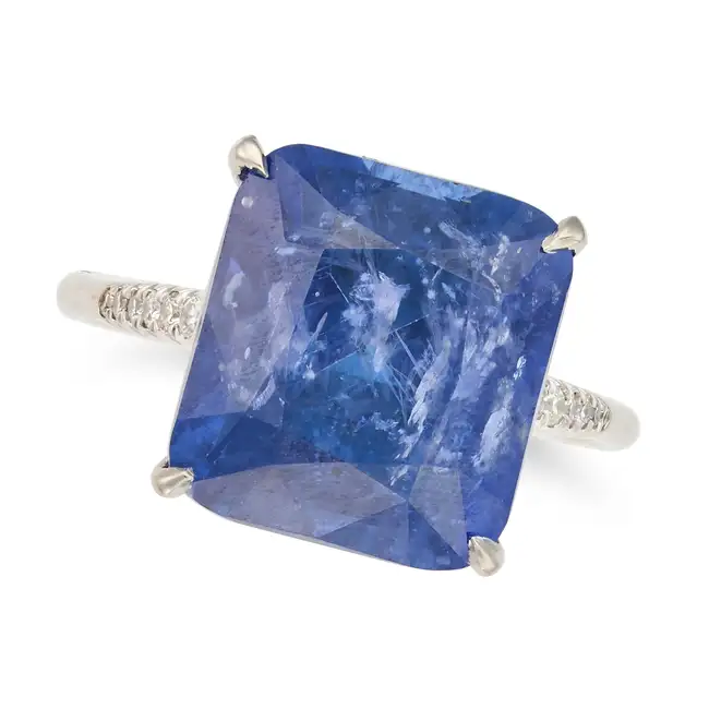 A SAPPHIRE AND DIAMOND RING set with a cushion cut sapphire of approximately 9.45 carats, the