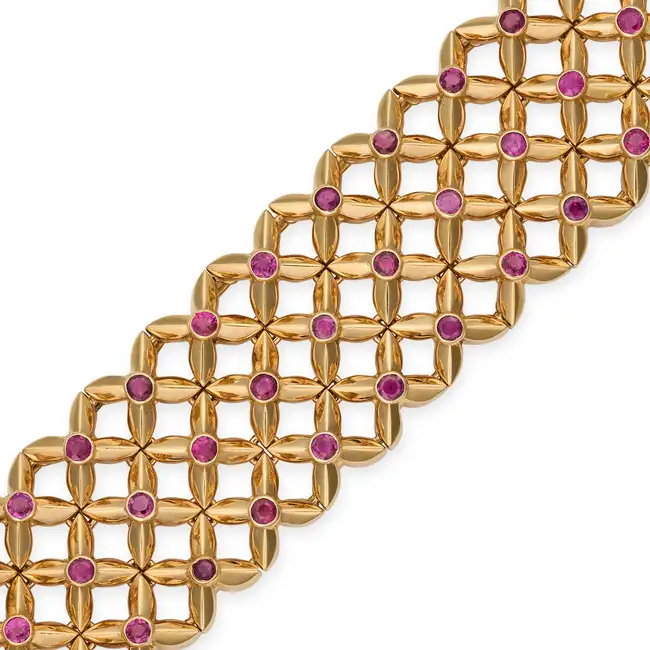BOUCHERON, A VINTAGE RUBY BRACELET in 18ct yellow gold, in lattice design, set with round cut