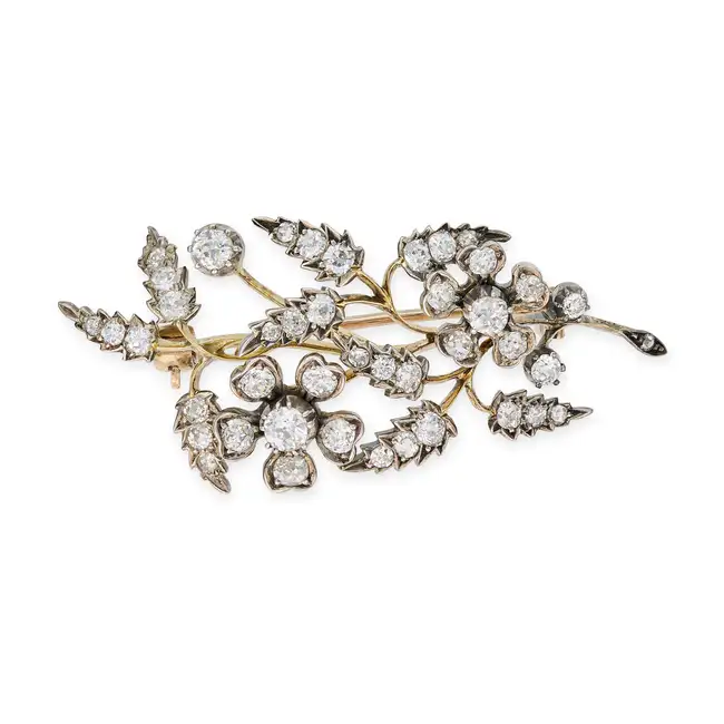 AN ANTIQUE DIAMOND SPRAY BROOCH in yellow gold and silver, designed as a foliate spray, set with old