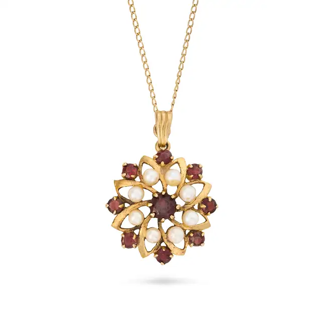 A VINTAGE GARNET AND PEARL PENDANT NECKLACE, 1975 in 9ct yellow gold, the pendant designed as a