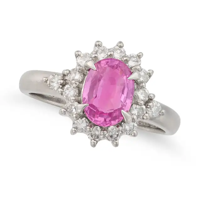 NO RESERVE - A PINK SAPPHIRE AND DIAMOND DRESS RING set with an oval cut pink sapphire of 1.26