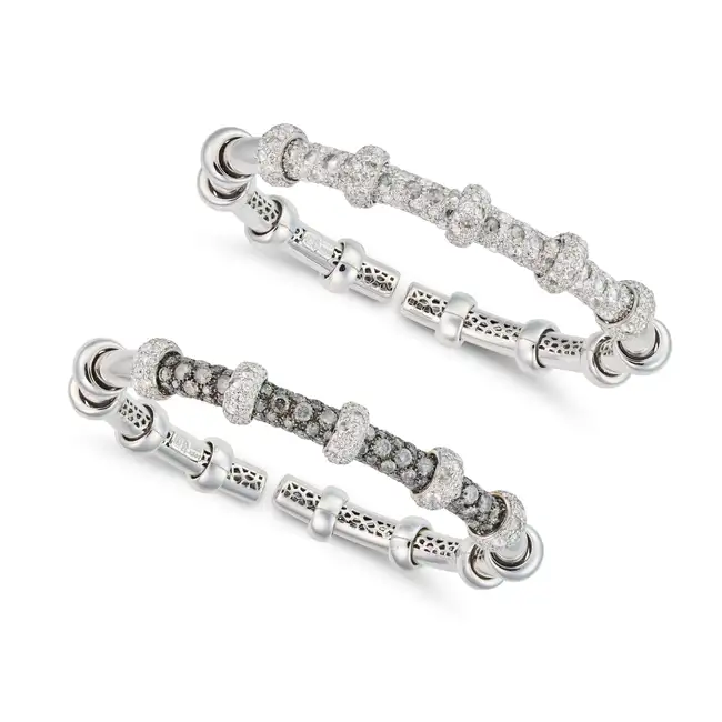A PAIR OF ITALIAN DIAMOND BANGLES in 18ct white gold, each in identical ridged design, one set