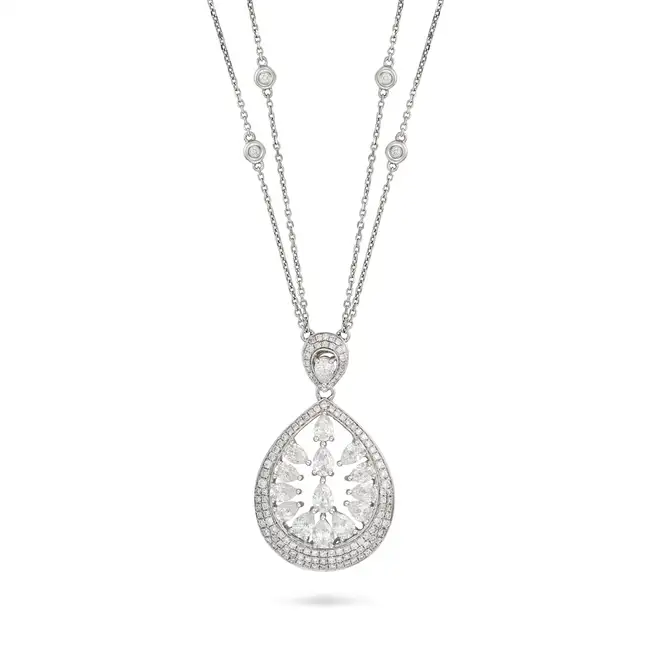 A DIAMOND PENDANT NECKLACE in 18ct white gold, the openwork pendant set with pear brilliant cut
