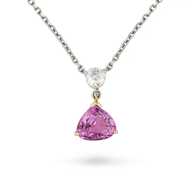 A PINK SAPPHIRE AND DIAMOND PENDANT NECKLACE set with a round brilliant cut diamond of approximately