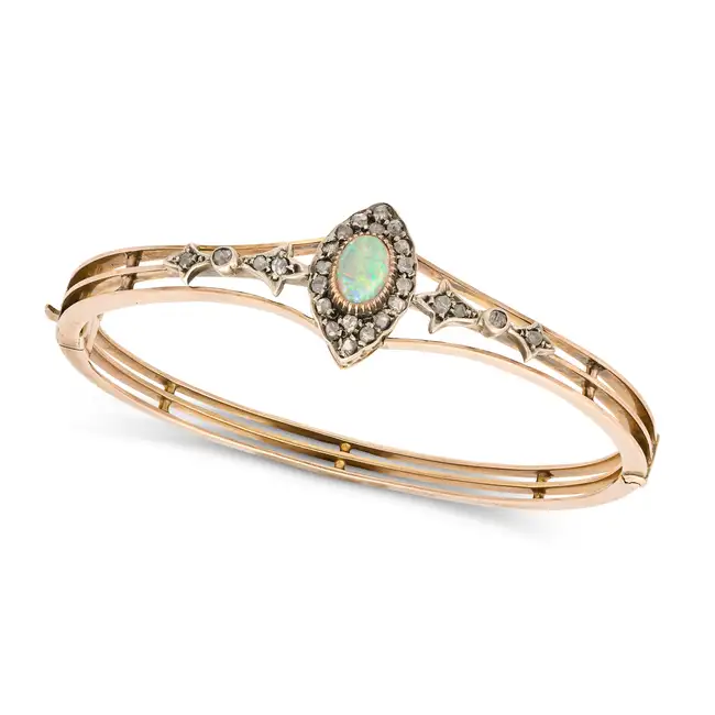 AN ANTIQUE OPAL AND DIAMOND BANGLE in yellow gold and silver, the hinged bangle set with an oval