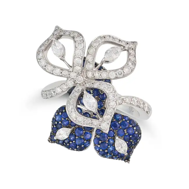 A SAPPHIRE AND DIAMOND FLOWER RING designed as stylised flowers set with marquise and round
